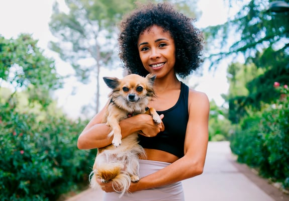 A woman holding her Chihuahua.