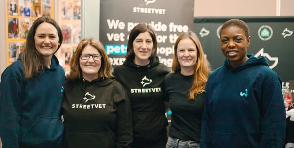 Members of Waggel and StreetVet stood in a line and smiling.