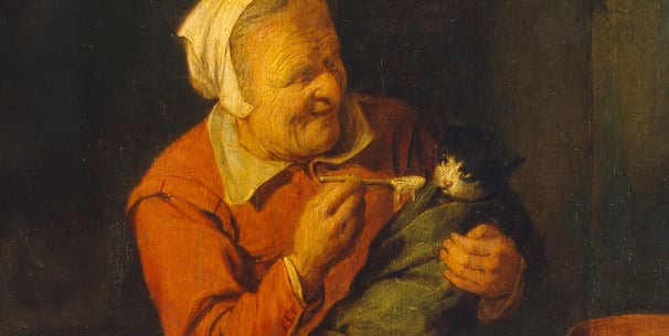 A painting of an old peasant woman feeding a cat with a spoon.
