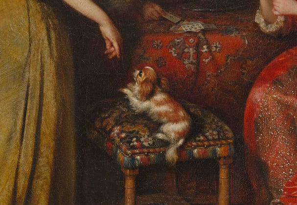 Historical painting of women in dresses with a Cavalier King Charles Spaniel on a stool in the middle