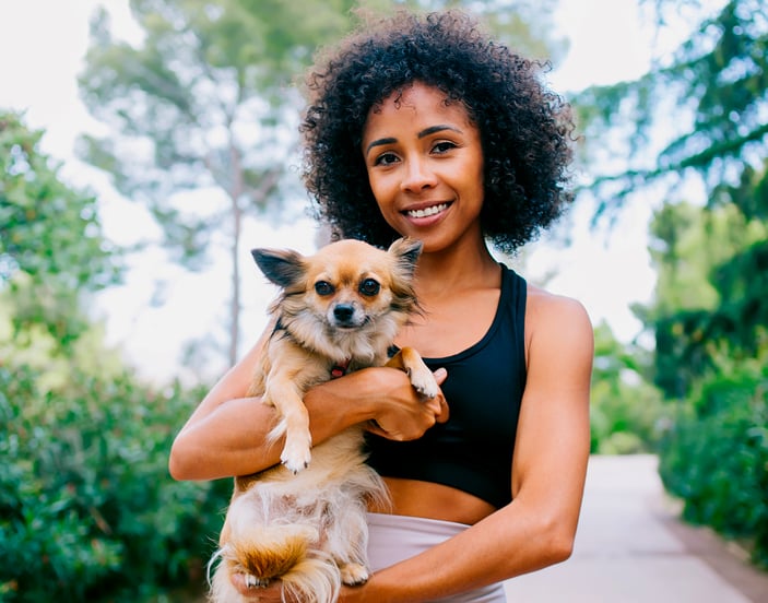 A woman holding her Chihuahua.