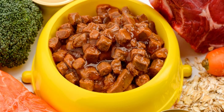 a close up of wet dog food in a yellow bowl