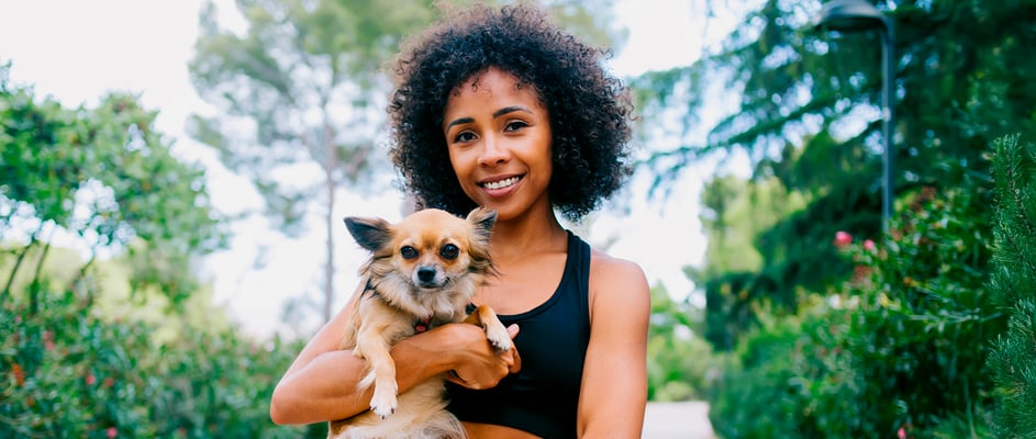 A woman holding her Chihuahua.